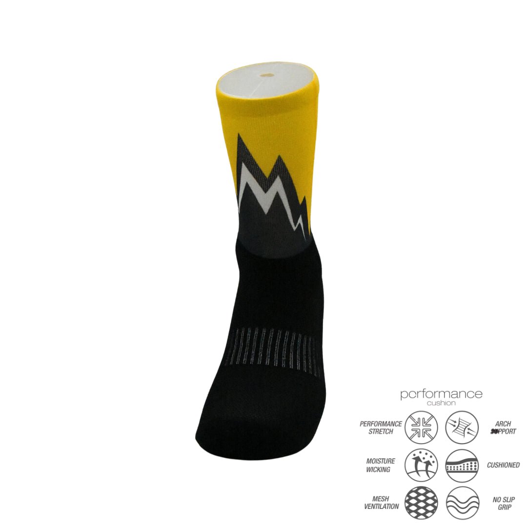 Yellow and black athletic performance sock with mountain design and moisture-wicking features