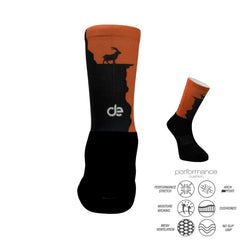 Black and orange performance athletic socks with mountain goat design, featuring cushioned arch support and moisture-wicking fabric